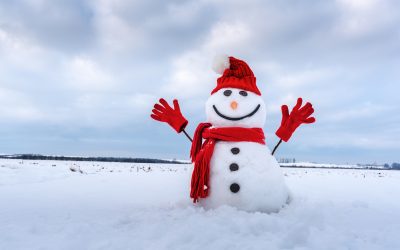 snowman in powdery snow building a snowman